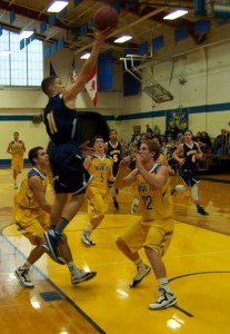 Emmanuel Perry gets air as he drives against the men Owls of UMPI. Emanuel contributed 3 points and 2 wins in the Men Seawolves win against UMPI>