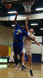 Jacob Loveridge battles it out under the boards against Eastern Maine Community College.